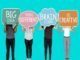 A group of people holding up speech bubbles that say big brain, attempting to change the way of thinking.
