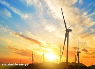 Sustainable Energy: The Breakthrough Wind turbines elegantly silhouette the hill at sunset, with "sustainable energy" emblazoned across the scene, capturing the essence of renewable power.