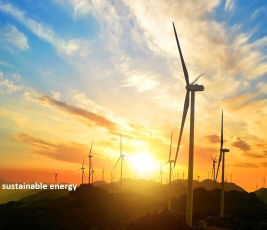 Wind turbines elegantly silhouette the hill at sunset, with "sustainable energy" emblazoned across the scene, capturing the essence of renewable power.