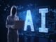 A person in a hoodie using a laptop stands next to a large digital AI sign, illuminated with circuit patterns, amidst the intriguing world of AI agents on a dark tech-themed background.