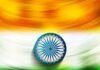 Abstract painting of the Indian flag with saffron, white, and green horizontal stripes and a blue Ashoka Chakra (sudarshan chakra) in the center.