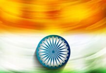 Abstract painting of the Indian flag with saffron, white, and green horizontal stripes and a blue Ashoka Chakra (sudarshan chakra) in the center.